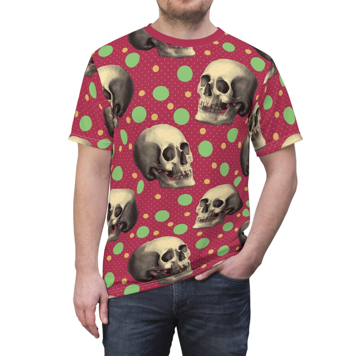 Vintage skulls on a red background with green and yellow polka dots cover this patterned tee shirt.