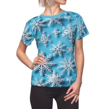 All over print t-shirt featuring a seamless wrap around graphic of white snowflakes on a bright blue background.