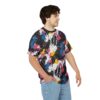 Splashes of pink, blue, yellow, and white cover this graphic streetwear tee, set against a black background with dynamic paint splatters.