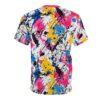 Bold splatters of pink, yellow, blue, and black paint cover this patterned tee shirt, creating a chaotic yet artistic Jackson Pollock-inspired design.