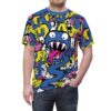 All over print t-shirt features a vibrant cartoon monster with sharp teeth and a long pink tongue surrounded by yellow and pink abstract shapes and white doodles.