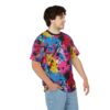 Bright blue, hot pink, yellow, and purple paint splatters with black and white accents cover this oversized full print tee, creating a chaotic abstract art design.