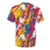 Yellow, red, blue, black, and white paint splatters and drips cover this seamless pattern tee, creating a chaotic yet vibrant abstract design.