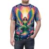 A woman with rainbow wings sits in a river surrounded by flowers and trees, with a bright sunburst behind her. The design is printed on a t-shirt.
