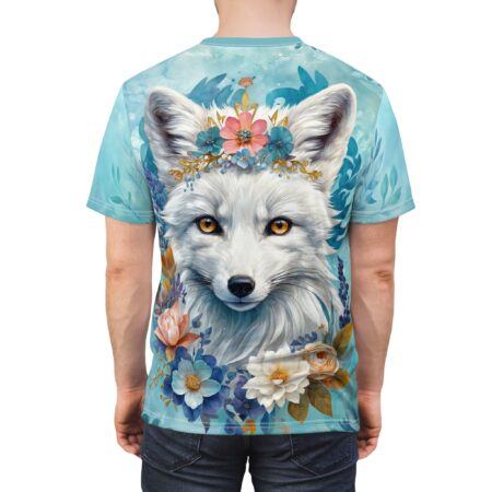 White fox with golden eyes and a floral crown, surrounded by blue and pink flowers, covers this oversized full print tee, with a light blue watercolor background.