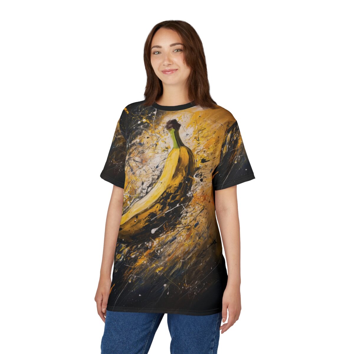 Splashes of yellow, black, and white paint cover this 3D graphic t-shirt, depicting a large banana against an abstract, energetic background.