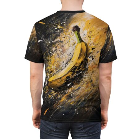 A vibrant banana graphic is depicted with bold yellow and black paint splatters across a black crewneck t-shirt.