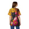 Vibrant oranges, yellows, and pinks cover this graphic streetwear tee, a black cat with orange eyes sits amongst lush floral blooms and autumn leaves.