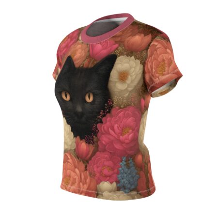 Black cat face peeking through a vibrant floral pattern all over print sublimation tee with pink, cream, and coral flowers.