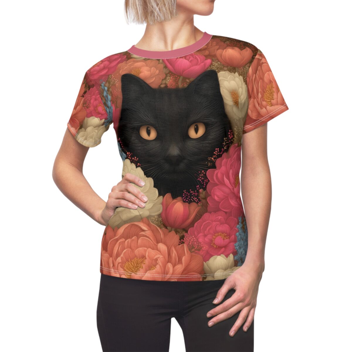Black cat with orange eyes peeking through a vibrant floral pattern, all over print sublimation tee.