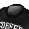 Black crewneck t-shirt with white varsity COFFEE text, daisy accents, and a checkered lightning bolt graphic design.
