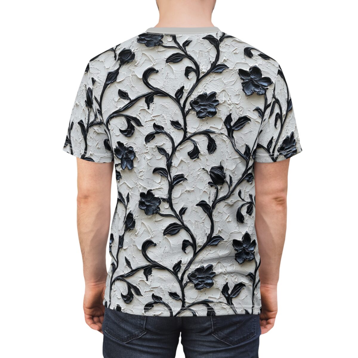 Impasto textured light grey fabric with raised black floral vines and dark blooms covers this oversized full print tee, creating a tactile and dramatic visual.