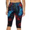 Capri leggings with a dark floral print featuring vibrant blue butterflies and red roses.
