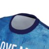 Blue t-shirt with a textured abstract design and white lettering.