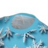 White, three-dimensional snowflakes are scattered across a bright blue background on this sublimation graphic tee.