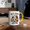 White ceramic mug with yellow handle and rim, featuring a cute sloth illustration and the text "BUSY DOING NOTHING".