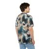 Teal and navy butterflies with detailed wings and cream-colored flowers cover this patterned tee shirt, with a bright white background.