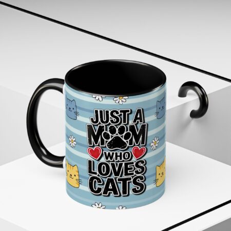 Ceramic mug with blue stripes, cute cats, and "Just a Mom Who Loves Cats" text. Black handle and interior.