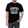 Black t-shirt with white text 'COFFEE MAKES ME NICER' and daisy graphics. Features a checkerboard lightning bolt.