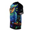 Vivid blues, greens, and yellows cover this graphic streetwear tee, depicting a colorful owl perched on a branch with swirling vines and leaves against a starry night sky.