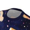 Close-up of a dark blue t-shirt with a celestial print featuring a cat silhouette, stars, and planets.