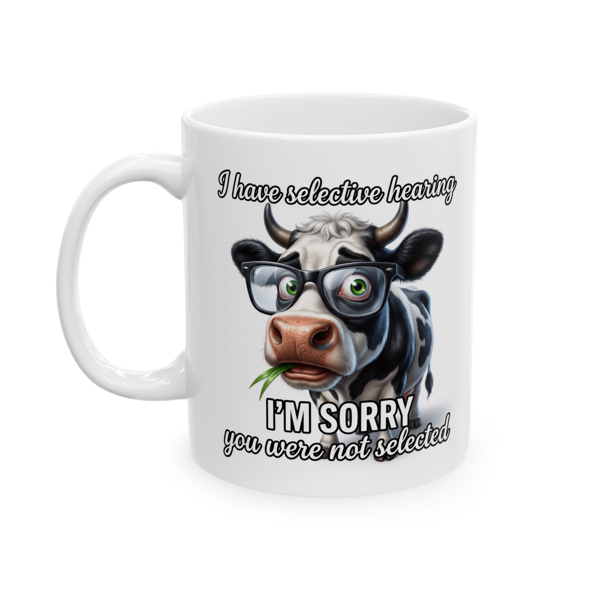 A white ceramic mug with a black and white cow wearing glasses and the text "I have selected hearing - I'm sorry you were not selected."