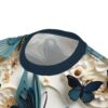 Teal and cream floral patterns with dark blue butterflies cover this 3D graphic t-shirt, depicting a nature-inspired scene.