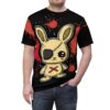 Red splatter patterns and white dots cover this black tee shirt, featuring a stitched, one-eyed bunny with an eyepatch and a red X.