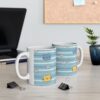 Two white ceramic mugs with a playful pattern of blue stripes, cute cat faces, and white daisies.