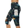 Capri leggings featuring a dark blue print with white cats, yellow ducks, brown otters, and small white flowers.