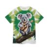Green palm fronds and a white background cover this sublimation graphic tee, depicting a cute koala playing a ukulele on a mossy branch.