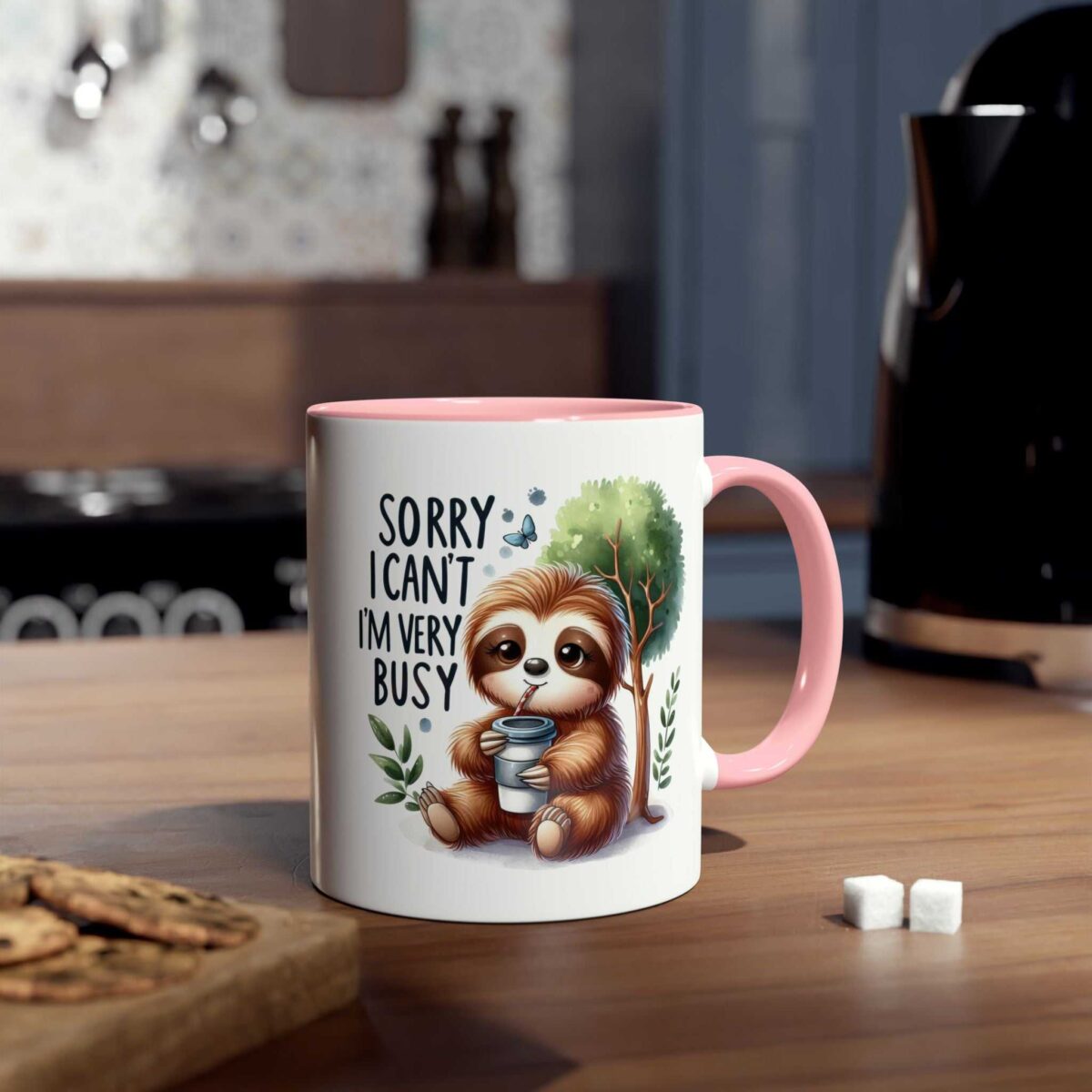 White ceramic mug with a pink interior and handle, featuring a cartoon sloth drinking coffee with the words "Sorry I can't I'm very busy."