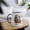 White mug with a blue interior and handle, featuring a cute sloth sitting in a chair, holding a coffee cup that says "first coffee".