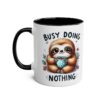 Cute cartoon sloth holding a polka dot mug of coffee, with "Busy Doing Nothing" text.