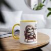 Ceramic mug with a yellow handle and rim. Features a fluffy sloth illustration sitting in a chair, holding a coffee cup.