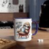White ceramic mug with a blue handle, showcasing a cartoon sloth with sunglasses holding a coffee mug.