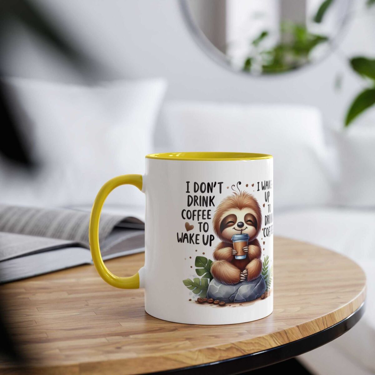 White ceramic mug with yellow handle and rim, featuring a cartoon sloth holding a coffee cup and text.