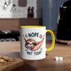 White ceramic mug with yellow handle, featuring a sleeping sloth in a hammock with text.