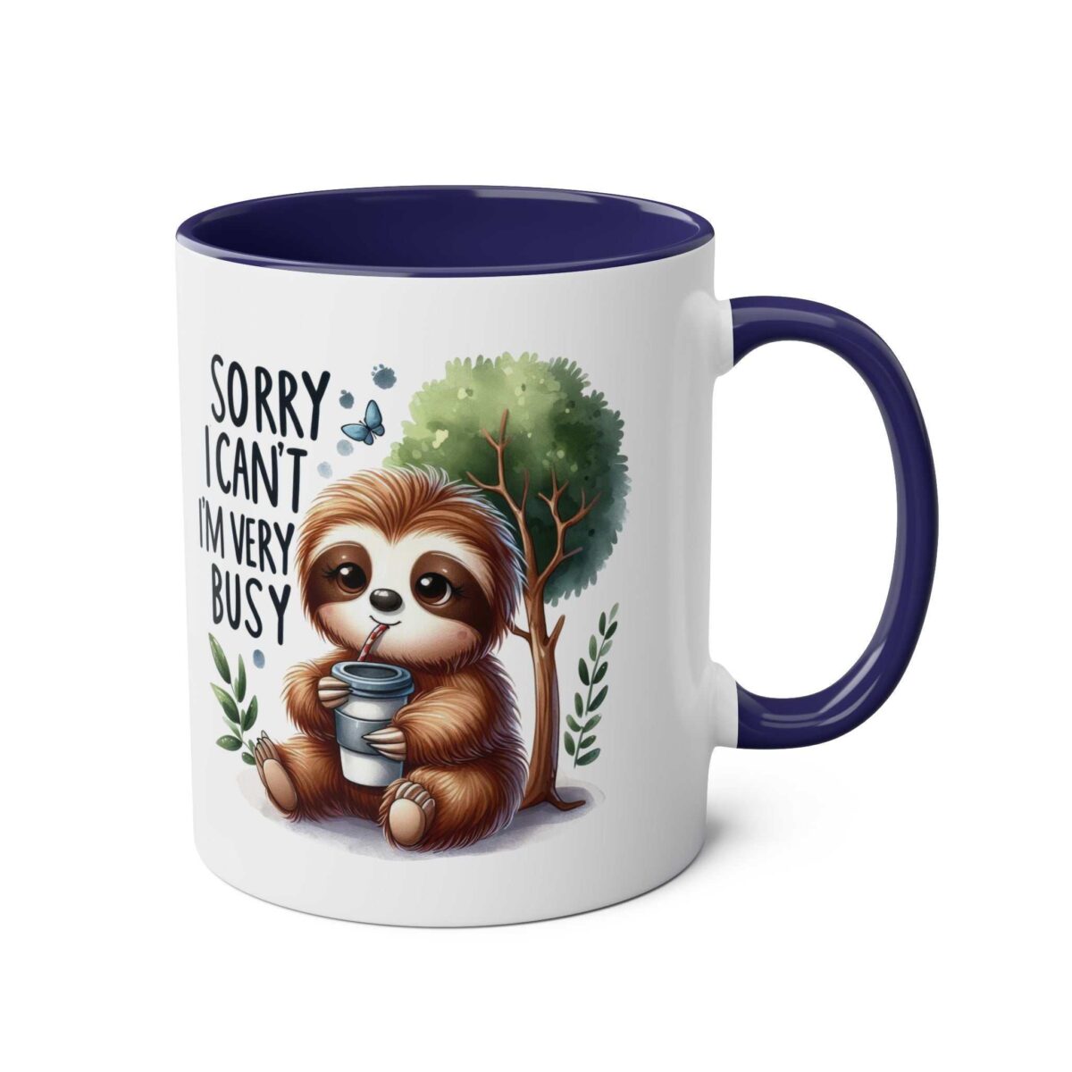 White ceramic coffee mug with a navy blue handle and interior, featuring a cute sloth illustration with text reading "Sorry I Can't I'm Very Busy."