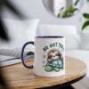 White ceramic mug with navy blue interior and handle, featuring a cute sloth sleeping on a turtle.