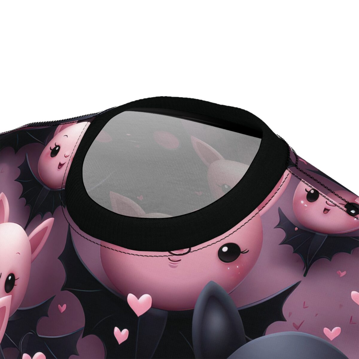 Pink bats with black wings and tiny hearts cover this patterned tee shirt, set against a soft purple background.