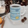 White ceramic mug with blue stripes and cute cat and daisy designs.