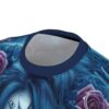 Swirling blue patterns and purple roses cover this all over print t-shirt, depicting a sugar skull with detailed face paint.