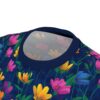 Bright pink, yellow, and blue flowers with green leaves scatter across this dark navy graphic streetwear tee, depicting a vibrant garden scene.