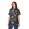 Pink and grey floral motifs with delicate branches cover this black graphic t-shirt, depicting a vintage botanical illustration.