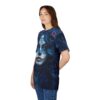 A woman models a dark blue t-shirt with a detailed sugar skull face and floral design.