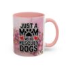 Ceramic mug with pink marble design and floral accents, reads 'JUST A MOM WHO RESCUES DOGS' with paw print.