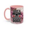 Ceramic coffee mug with pink handle, featuring the text 'JUST A MOM WHO RESCUES DOGS' surrounded by floral watercolor graphics.