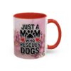 Ceramic coffee mug with pink marble background, featuring text 'Just a Mom Who Rescues Dogs' and floral accents.