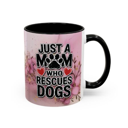 Ceramic mug featuring 'Just A Mom Who Rescues Dogs' text with paw print and heart graphics on a floral background.